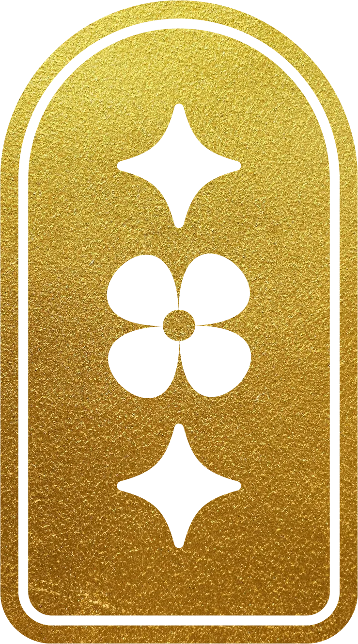 A gold surface with four cut-out symbols: a star, a circle with four petal shapes inside, an arrow pointing downward, and a horizontal line with a small vertical line beneath it.