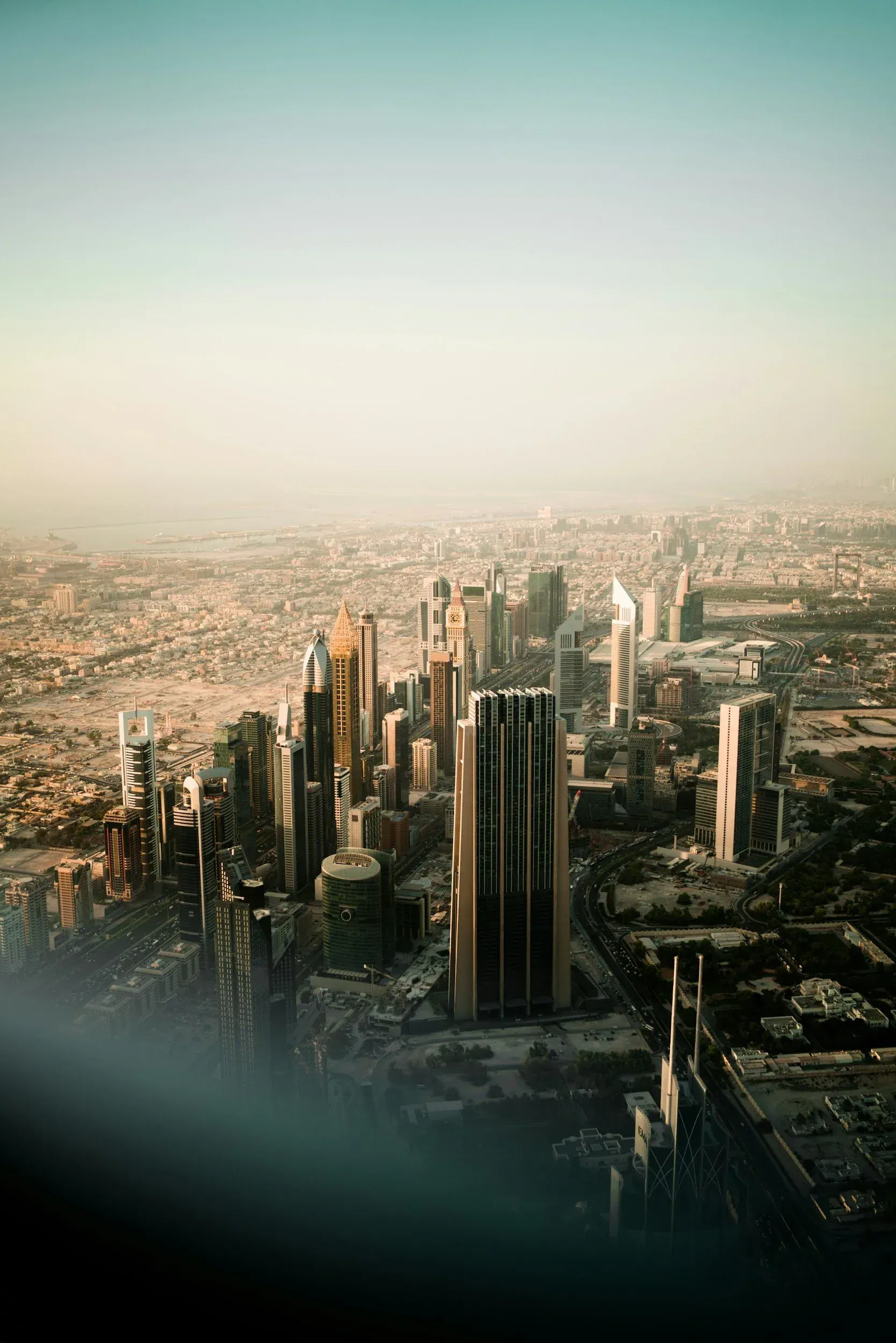 Aerial view of a city skyline with tall skyscrapers, likely a major city in the United States, under a clear sky.